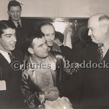 Joe DiMaggio, James J. Braddock and Postmaster General James A. Farley in Braddock's dressing room after the Tommy Farr fight, January 21, 1938