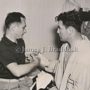 Doc. Robb cuts the tape off Jimmy's hands after a fight.