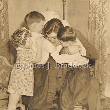 James Braddock plays with his children, Rose Marie, Howard and James